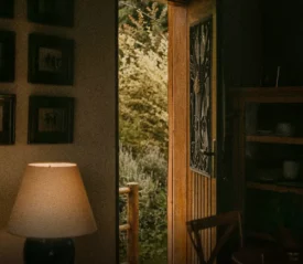 A quiet room with an open door leading outside, symbolizing faith and trust that God is in control even when the future is unseen and life feels uncertain.